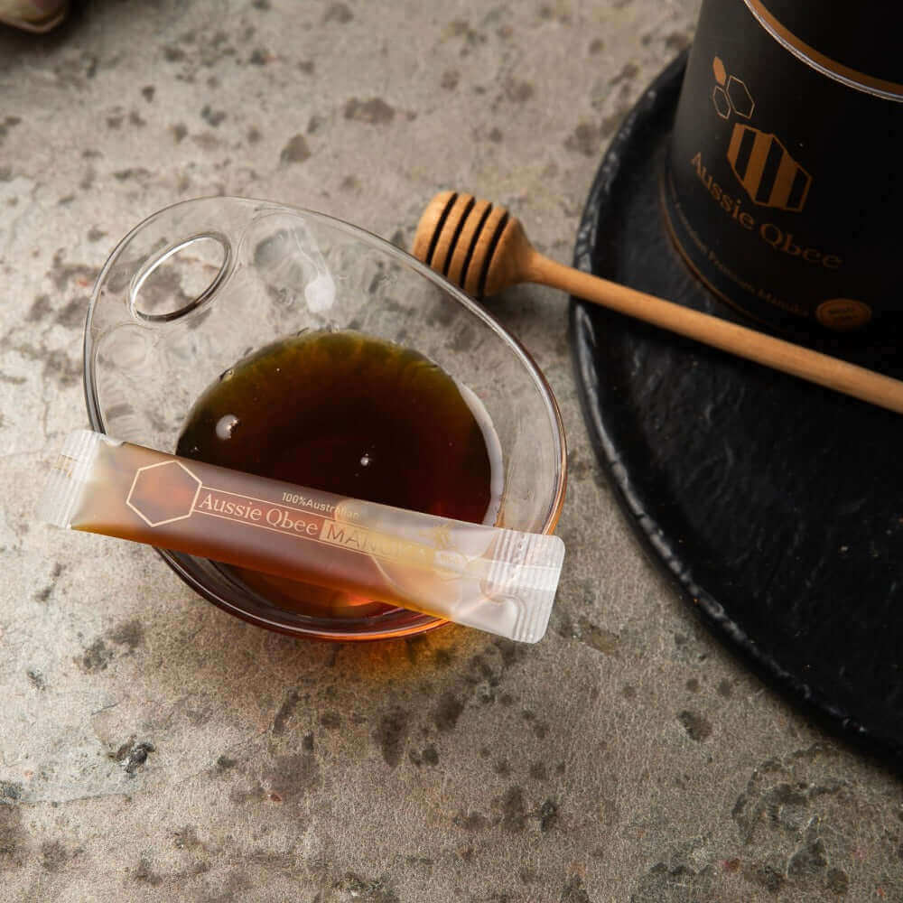 The Family Pantry Pack showcasing raw Australian Manuka honey in a glass bowl with a honey stick.