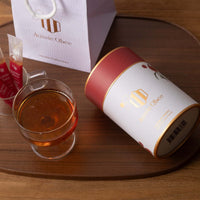 Ironbark Honey 360g from Aussie Obee in elegant packaging, poured into a glass, set on a wooden surface.
