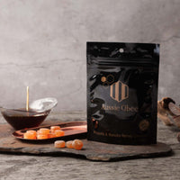 Propolis Lozenges 100g package with Manuka honey and lozenges displayed on a slate surface.