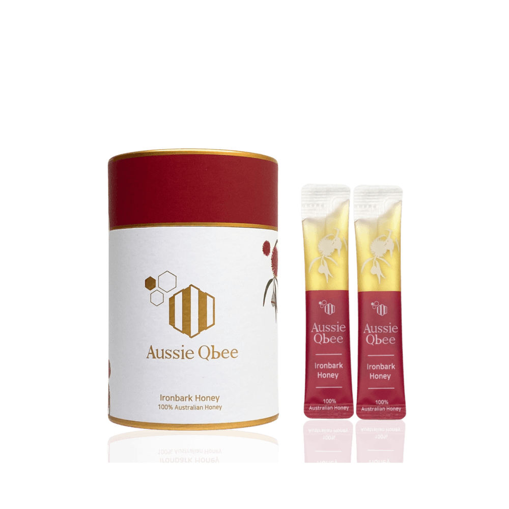 Ironbark Honey 360g by Aussie Qbee, featuring a cylindrical container and two honey sticks.