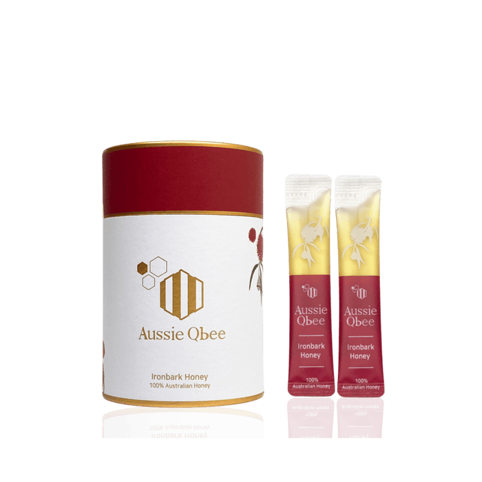 Ironbark Honey 360g by Aussie Qbee, featuring a cylindrical container and two honey sticks.
